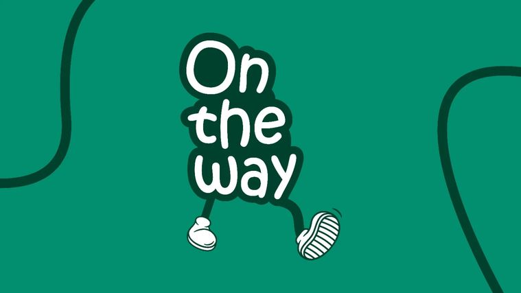 Logo On the Way : les mots « On the way » en lettres blanches arrondies sur fond vert sapin, posés sur deux jambes de dessin animé chaussées de baskets blanches, en pleine marche.